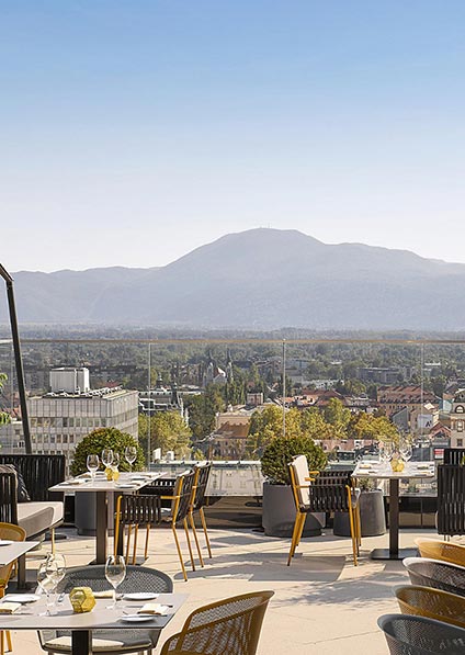 hotel Intercontinental in Ljubljana iis modernly designed with a rooftop terrace featuring a beautiful city view